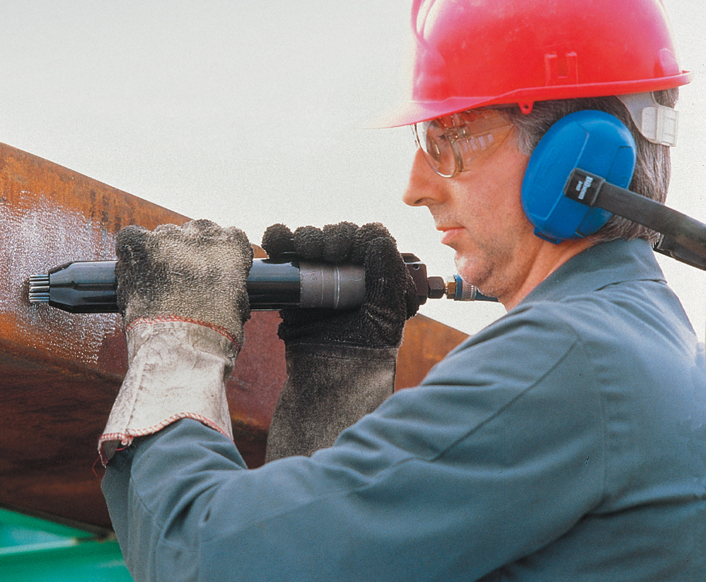Man using heavy-duty needle scaler